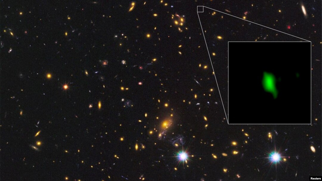 A galaxy located 13.28 billion light-years away is giving scientists new insight into the early history of the universe, with the detection of the oldest-known evidence of oxygen. Courtesy ALMA (ESO/NAOJ/NRAO), NASA/ESA Hubble Space Telescope, W. Zheng (JHU), M. Postman (STScI), the CLASH Team, Hashimoto et al/Handout