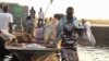 Refugees arrive by boat at the village of Mingkamen on the banks of the White Nile River