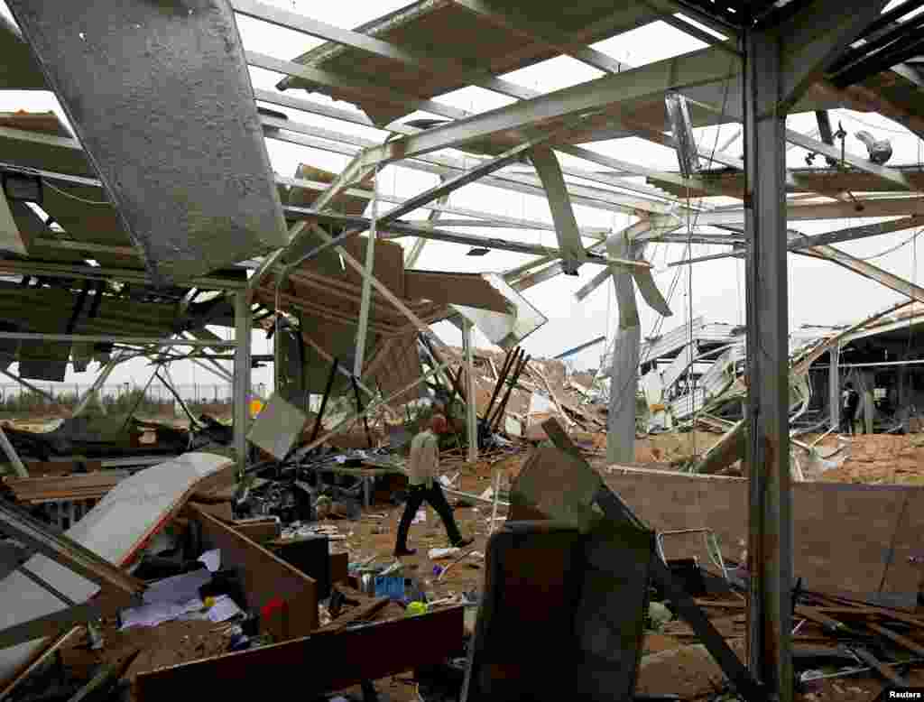 A worker checks the damages at a civilian airport under construction which, according to Iraqi religious authorities, was hit by a U.S. airstrike, in the holy Shi'ite city of Kerbala, Iraq.