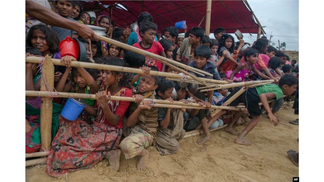 FILE - Rohingya Muslim children, who crossed over from Myanmar into Bangladesh, are squashed together as they wait to receive food handouts distributed to children and women by a Turkish aid agency at Thaingkhali refugee camp, Bangladesh, Oct. 21, 2017.