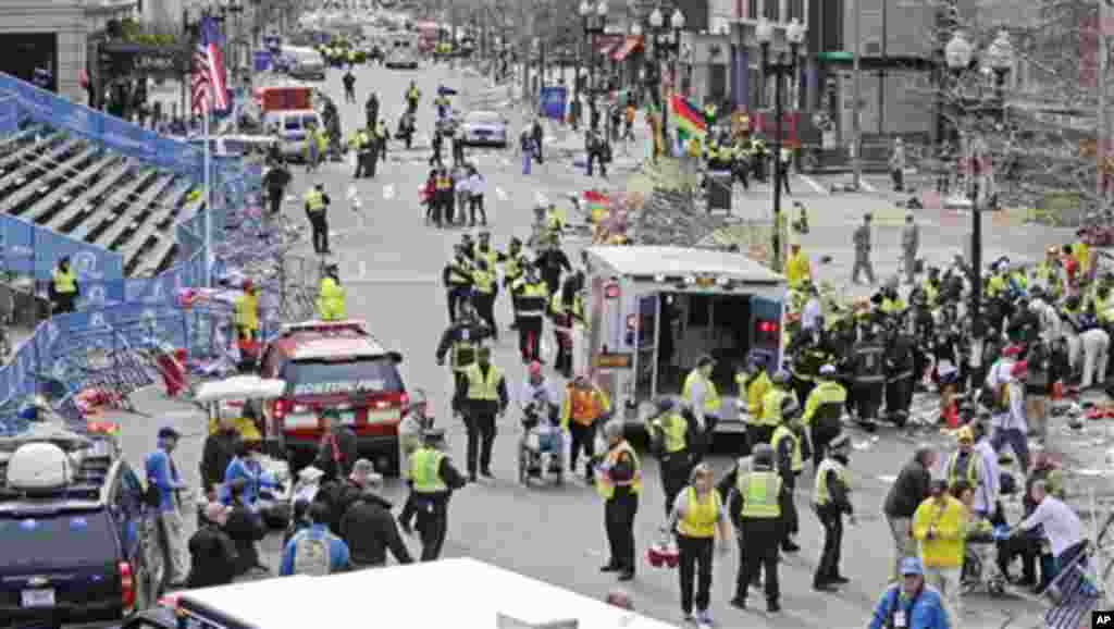 Paramédicos ajudam feridos junto à linha de chegada da Maratona de Boston 2013, após as explosões no dia 15 de Abril de 2013.