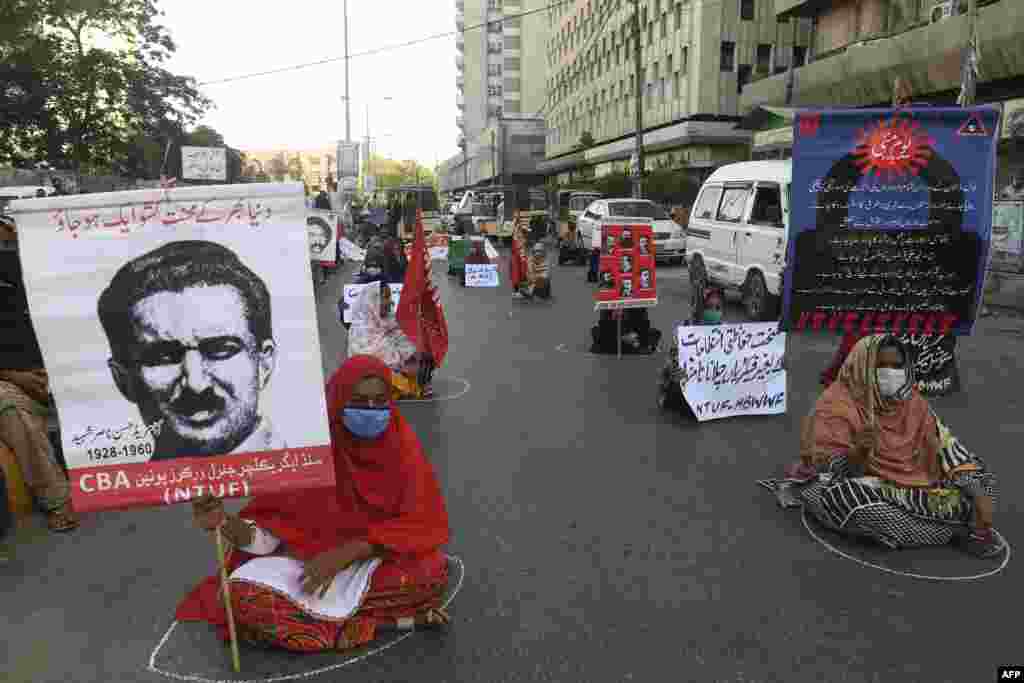 Labor union workers keep social distancing as they carry signs during a May Day rally in Karachi, Pakistan.