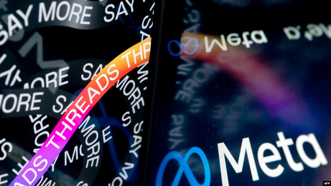 This photo illustration created in Washington, DC, on July 6, 2023, shows the opening page of Threads, an Instagram app, near the Meta logo.
