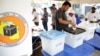 A voter casts his ballot during presidential and parliamentary elections at the Ukombozi primary school in Dar es Salaam, Tanzania, Oct. 28, 2020.