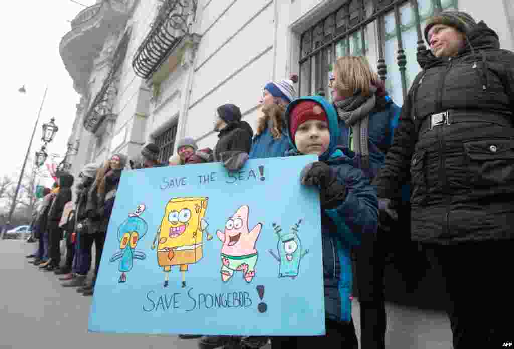 A youth holds a placard during a "Fridays for Future" climate strike outside the Federal Chancellery in Vienna.