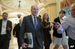 Senate Minority Leader Chuck Schumer, D-N.Y., is met by reporters as he arrives at the Capitol on the first morning of a partial government shutdown, Dec. 22, 2018.
