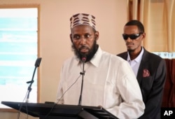 In this Oct. 10, 2018, photo, Mukhtar Robow, who was once deputy leader of Africa's deadliest Islamic extremist group, al-Shabab, speaks at a press conference about his candidacy for a regional presidency, in Baidoa, Somalia.