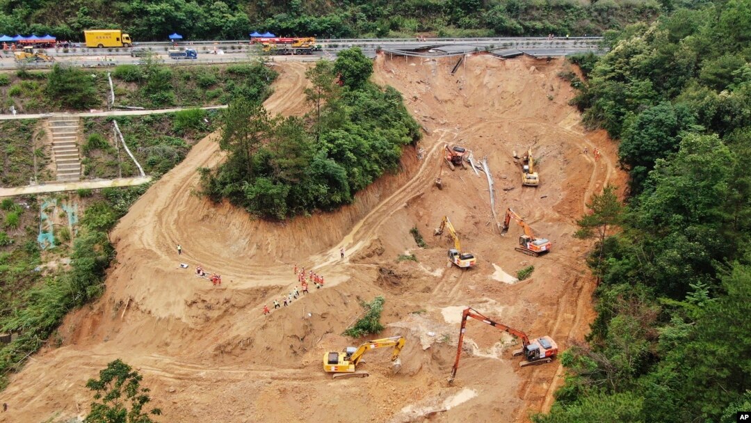 This aerial drone photo taken on May 2, 2024, shows rescuers and excavators working at the site of a highway section that collapsed on the Meizhou-Dabu Expressway in Meizhou, China. (Xinhua News Agency via AP)
