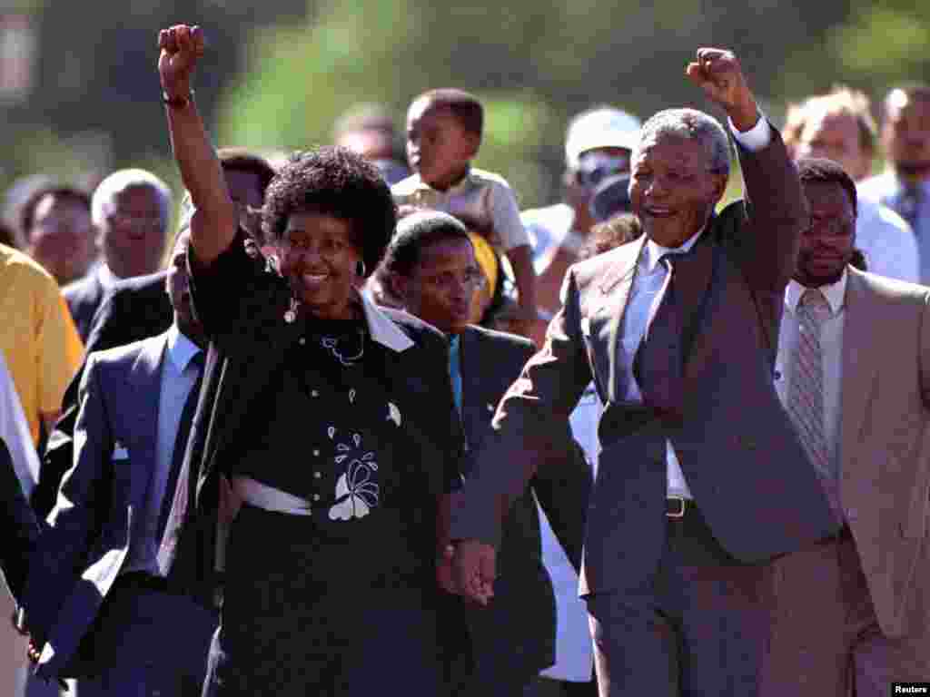 Nelson Mandela and his then wife, Winnie, salute well-wishers as he leaves Victor Verster prison on February 11, 1990.