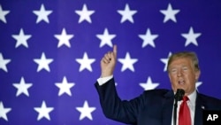 FILE - President Donald Trump speaks at a fundraiser in Fargo, N.D., Sept. 7, 2018. Trump is assailing investigative journalist Bob Woodward's book about him and his White House as 'just another assault against me, in a barrage of assaults.'