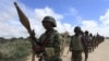 FILE - African Union Mission in Somalia (AMISOM) peacekeepers from Burundi patrol after fighting between insurgents and government soldiers erupted on the outskirts of Mogadishu.