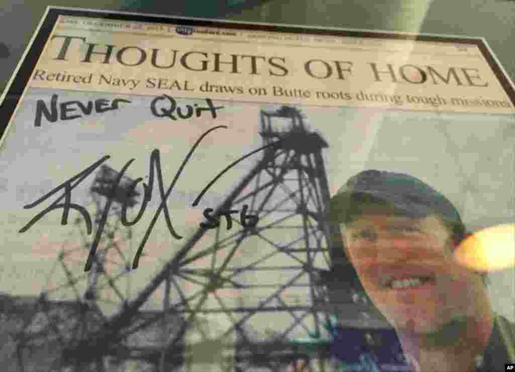 A framed Montana Standard newspaper article on Robert O'Neill, with his autograph, is seen on the wall of the Metals Sports Bar in Butte, Montana, Nov. 6, 2014.