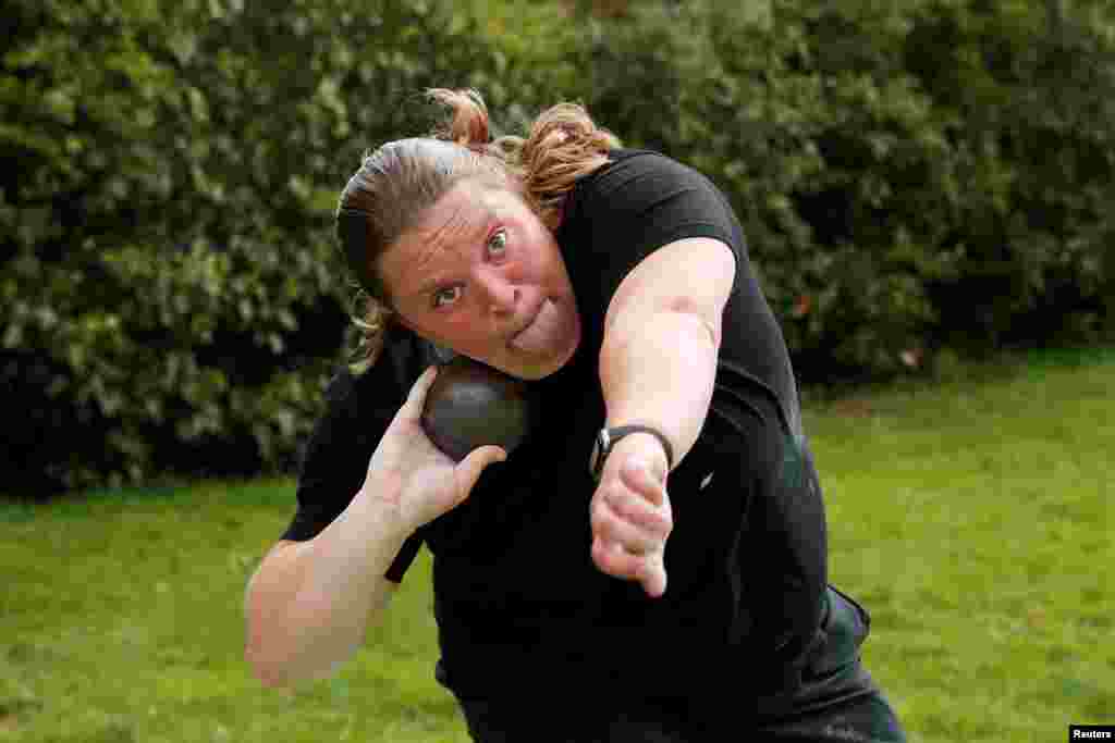British Shot Putter, Sophie McKinna, exercises in her garden during the coronavirus pandemic, in Lound, Britain.