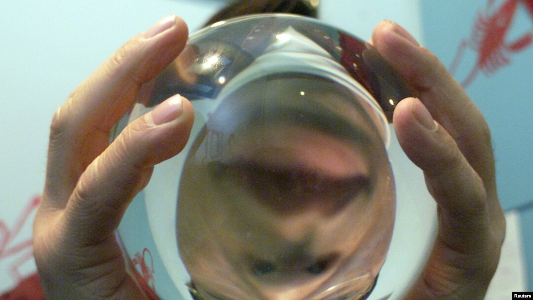 South Korean fortune teller Kim Yong-son poses with his crystal ball in his Seoul office. (File photo)