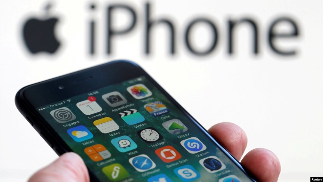 An Apple iPhone 7 and the company logo are seen in this picture taken, Feb. 1, 2017.