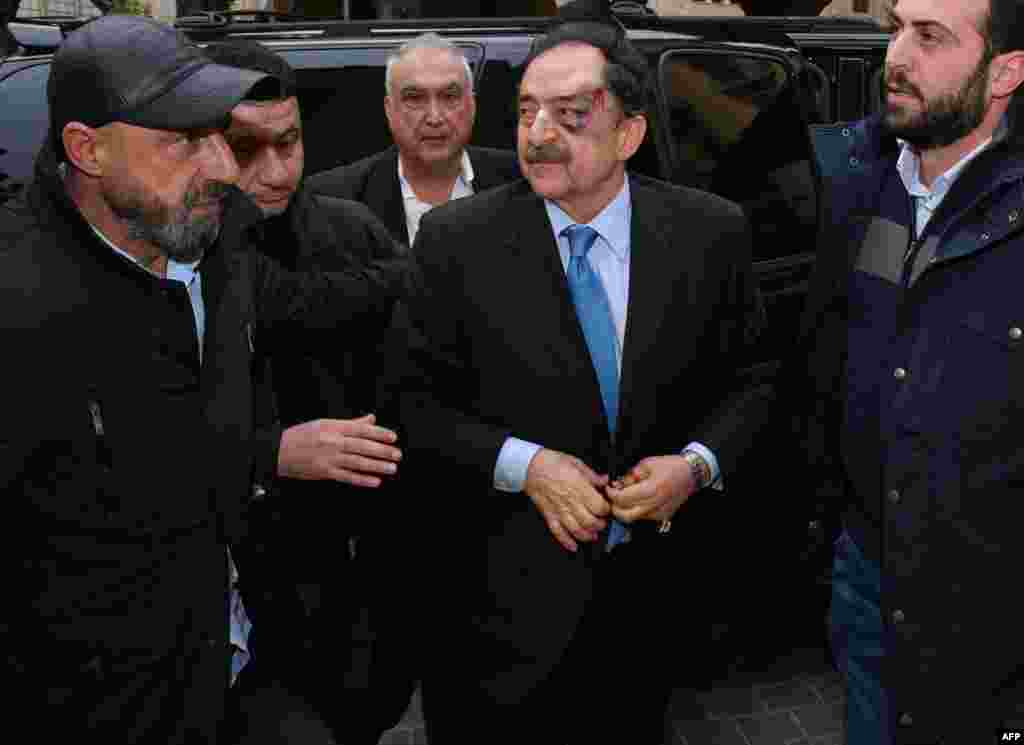 A handout picture provided by the Lebanese Parliament press office shows MP Salim Saade arriving to attend a parliamentary session after being attacked by protesters, in Beirut.