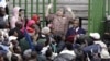 An immigration official addresses Zimbabweans outside an immigration office in downtown Johannesburg, South Africa, December 15, 2010, as they attempt to become legal. 