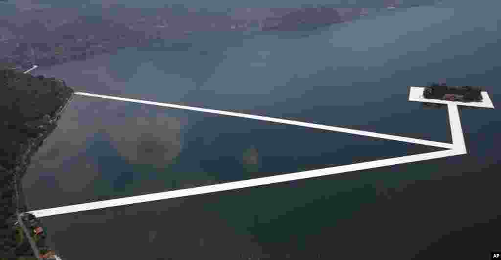 An aerial view of the installation 'The Floating Piers' by Bulgarian-born artist Christo Vladimirov Yavachev known as Christo, in progress, on the Lake Iseo, northern Italy, June 7, 2016.