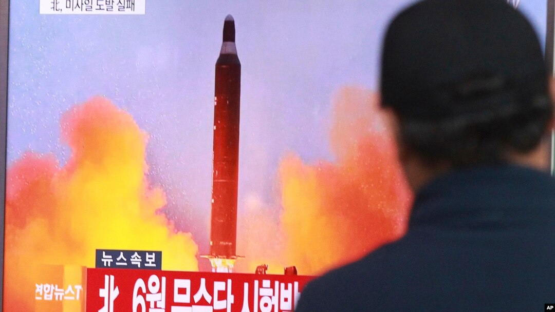 FILE - A man watches a TV news program, Oct. 16, 2016, showing a file image of a missile launch conducted by North Korea.