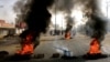 Sudanese protesters use burning tires to erect a barricade on a street, demanding that the country's Transitional Military Council hand over power to civilians, in Khartoum, Sudan, June 3, 2019.