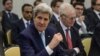 US Secretary of State John Kerry (L) gestures waiting for the opening of a plenary session with P5+1 ministers, European Union and Iranian minister on Iran nuclear talks at the Beau Rivage Palace Hotel in Lausanne, Switzerland, March 31, 2015.