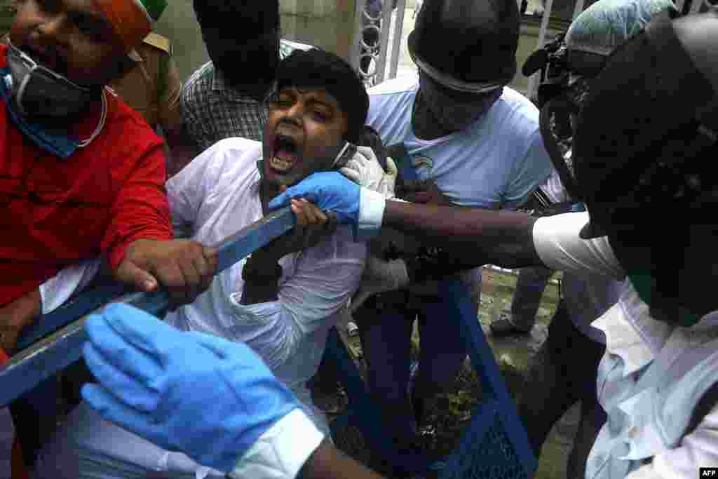 Activists of Congress Party shout slogans against the Bharatiya Janata Party (BJP) led central government and state Governors as they try to break police barricades in front of the Raj Bhavan (Governor's House) in Kolkata, India.