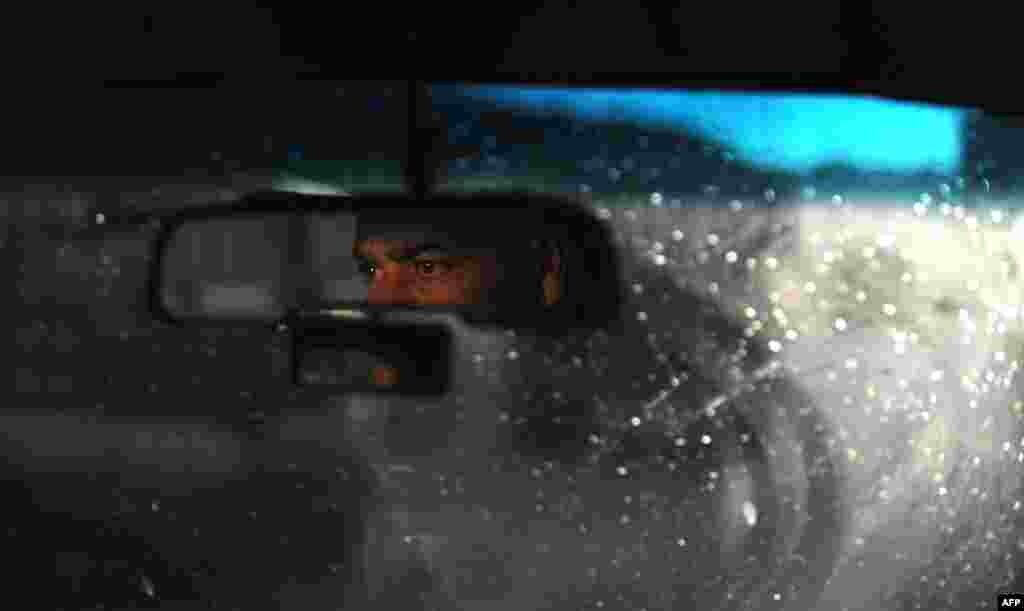 A Syrian man drives through Aleppo, March 28, 2013.