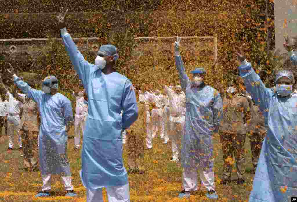 An Indian Air Force helicopter showers flower petals on the staff of INS Asvini hospital in Mumbai.
