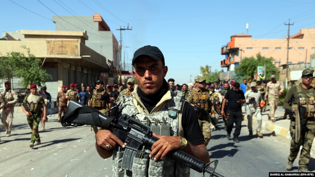 IRAQ -- Members of Iraqi Shiite group known as Hashd al-Shaabi (The Popular Crowd) patrol an area in Tuz, southern Kirkuk city, Iraq, 17 October 2017 (issued 18 October 2017)