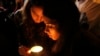 People light a candle for former president Nelson Mandela on hearing of his death outside his home in Johannesburg, South Africa, Dec. 5, 2013.