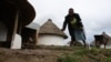 Lumka must walk with the aid of a crutch, but she often falls and hurts herself. (VOA/ D. Taylor) 