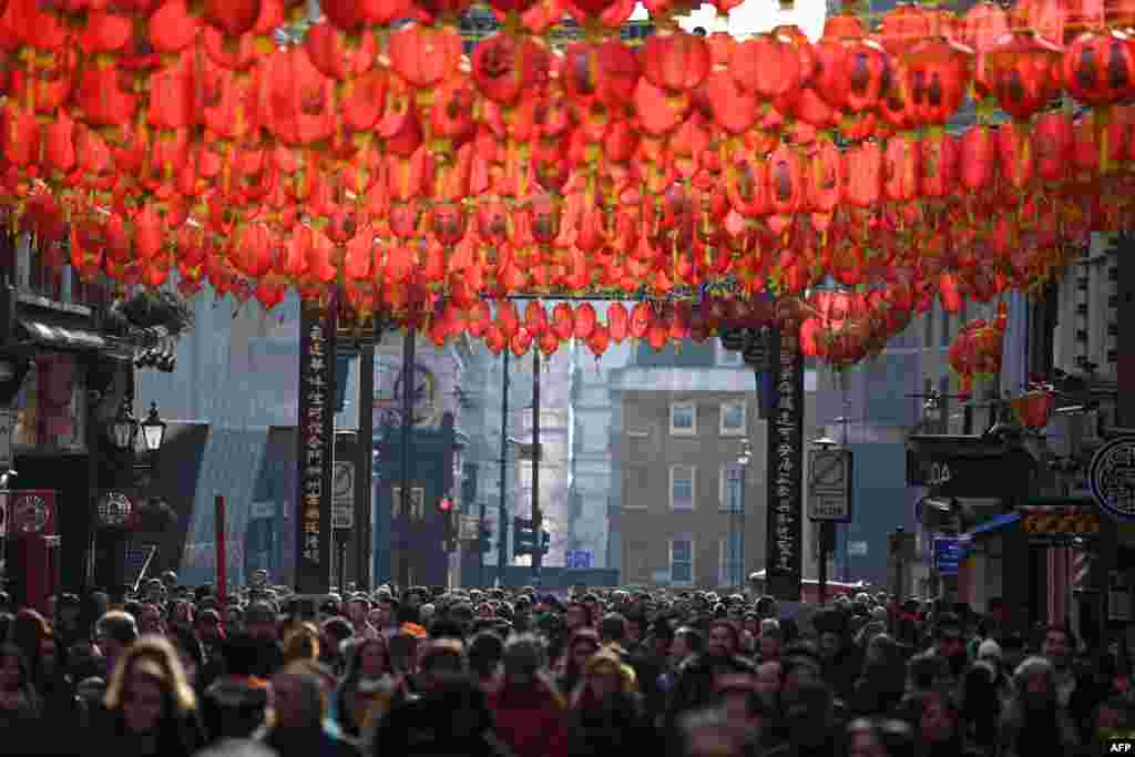 Crowds watch the celebrations for the Chinese Lunar New Year in London's China town in central London.
