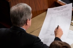 Sen. Roy Blunt, R-Missouri, signs an official tally to count Electoral College votes, certifying Donald Trump's presidential victory, Jan. 6, 2017.