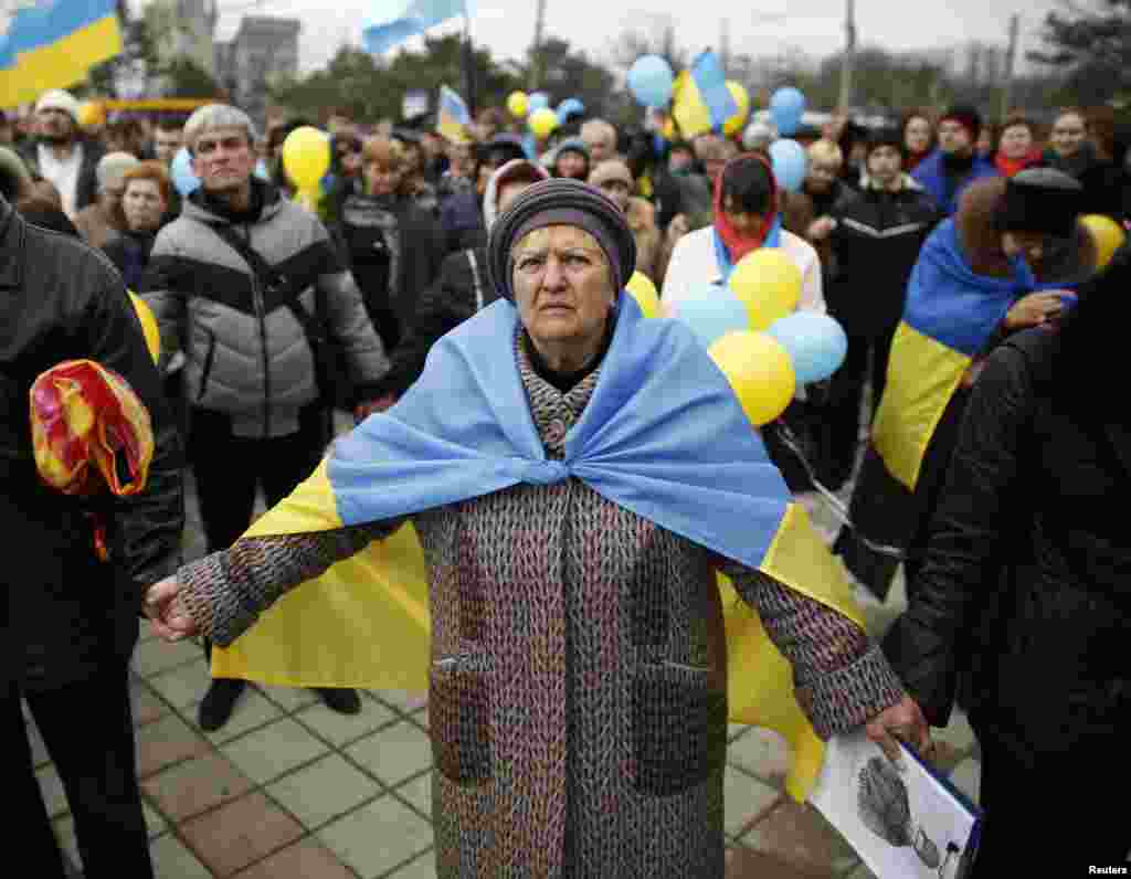 Pro-Ukrainian supporters join hands as they take part in a rally in Simferopol, Crimea, March 9, 2014.