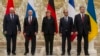 From left, Belarusian President Alexander Lukashenko, Russian President Vladimir Putin, German Chancellor Angela Merkel, French President Francois Hollande and Ukrainian President Petro Poroshenko pose during a break in their peace talks in Minsk, Belarus, Feb. 11, 2015.