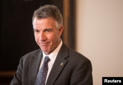 FILE - Vermont Gov. Phil Scott speaks to reporters in his offices at the State Legislature in Montpelier, March 13, 2018.