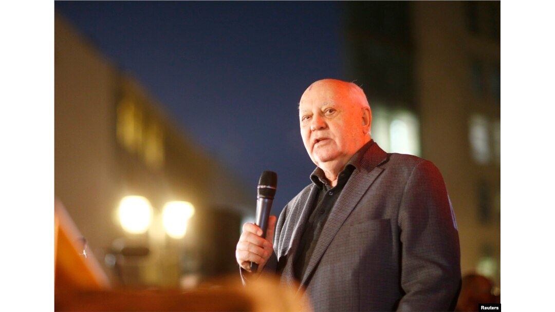FILE - Former Soviet President Mikhail Gorbachev visits the former Berlin Wall border crossing point Checkpoint Charlie, in Berlin, November 7, 2014.
