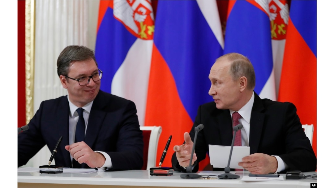 FILE - Russian President Vladimir Putin (R) and Serbian President Aleksandar Vucic talk to each other during a meeting with the media following their talks in the Kremlin in Moscow, Russia, Dec. 19, 2017.