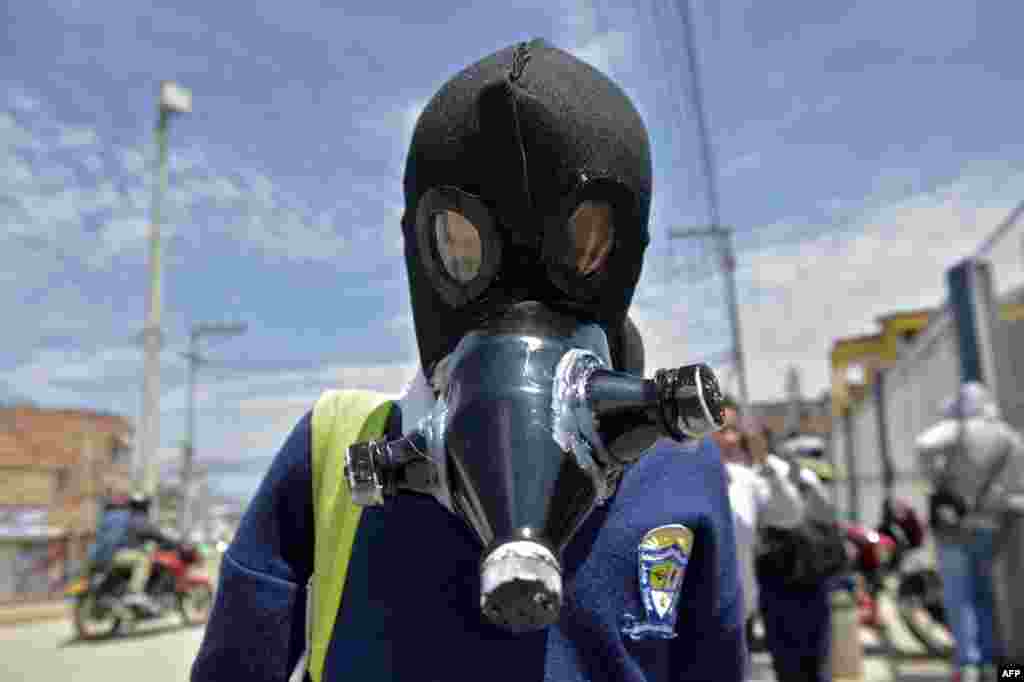 A student wears a face mask made with recyclable and biodegradable materials, as a form of protest against the shortage of face masks in pharmacies, in order to prevent the spread of the COVID-19 virus at Julio Cesar Turbay school in Soacha, Colombia.