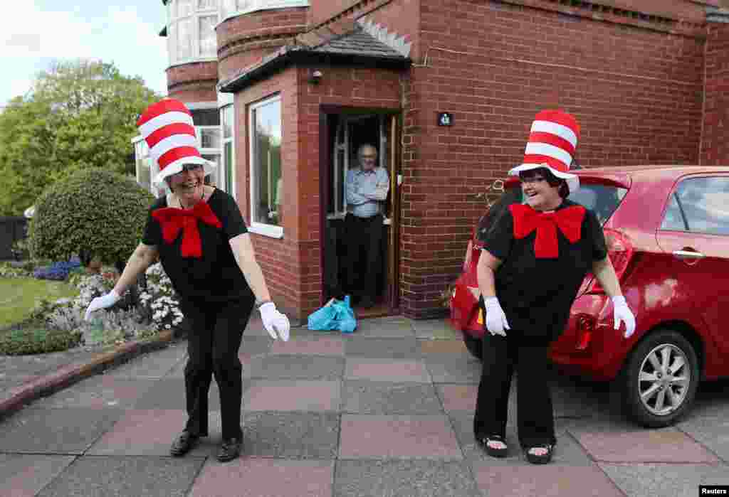Viv and Carol from St. James' church, dressed as the character Cat in the Hat, pose for a photograph as they deliver meals to vulnerable residents following the outbreak of the coronavirus disease (COVID-19), Bolton, Britain.