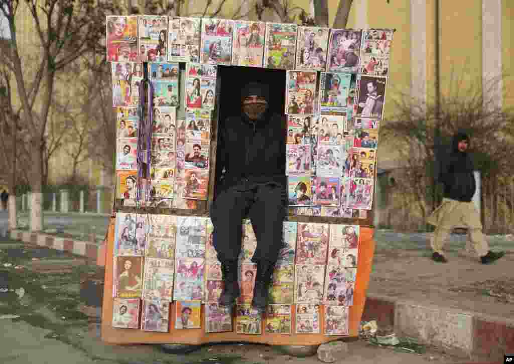A CD salesman waits for customers at his stall in Kabul, Afghanistan.