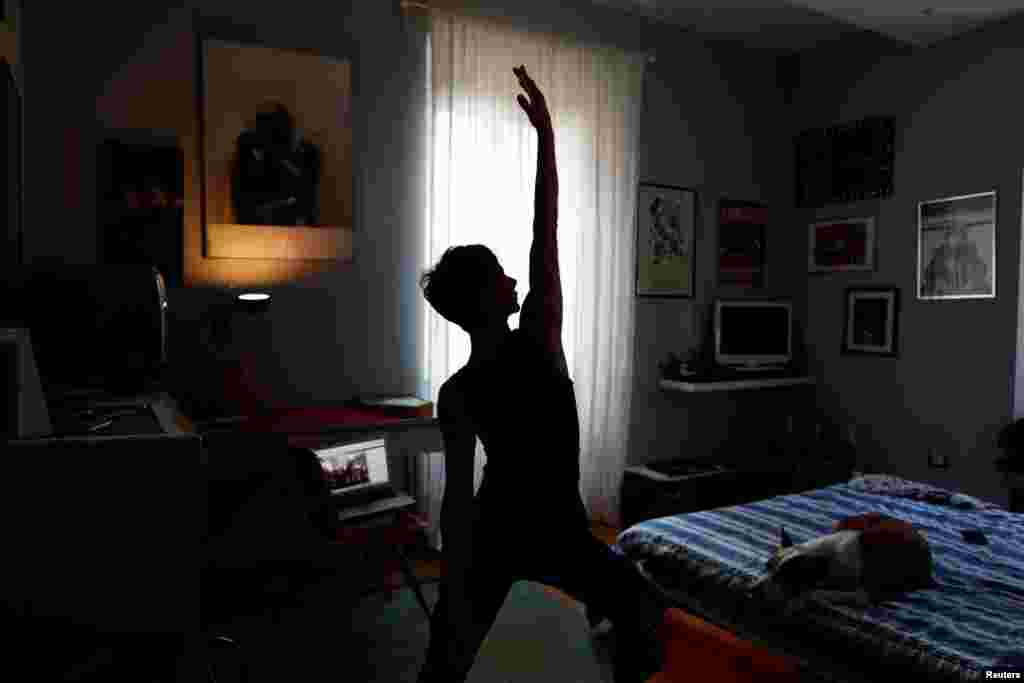 Francesca Valagussa, 40, practices yoga with an online course, in Rome, Italy, March 16, 2020.