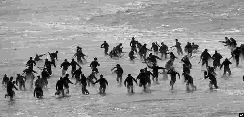 Actors perform on the beach in Dunkirk, France, during the filming of a scene for the film, Dunkirk.
