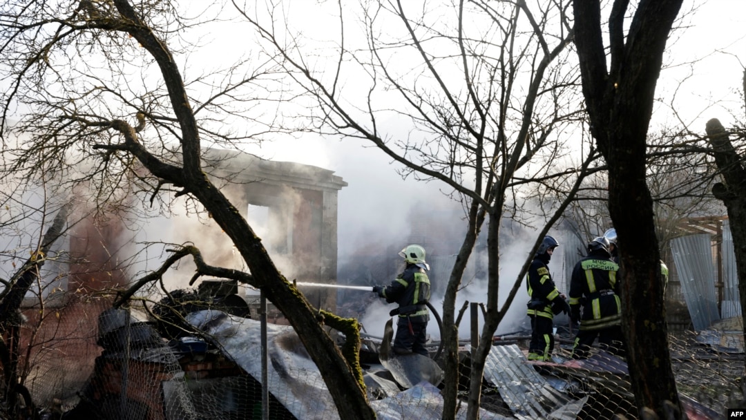 Rescuers work to extinguish a fire in a house following a drone attack in the village of Stanovoye, Moscow region, on November 10, 2024.