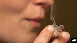 FILE - A person smoking a cigarette.