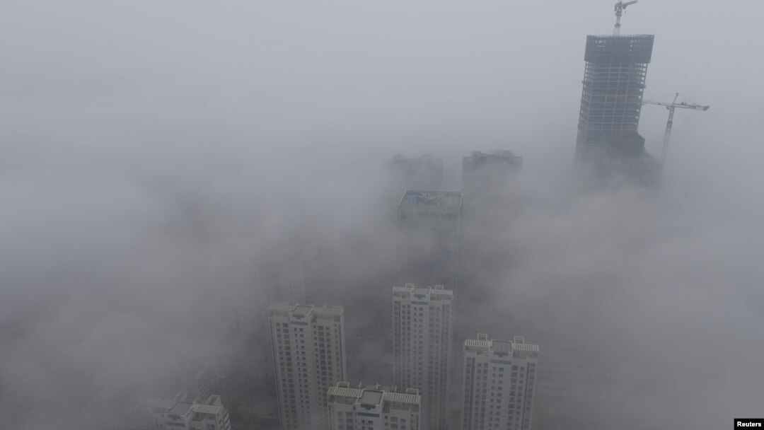 FILE -- Buildings are seen shrouded in heavy haze at Qingdao development zone, Shandong province.