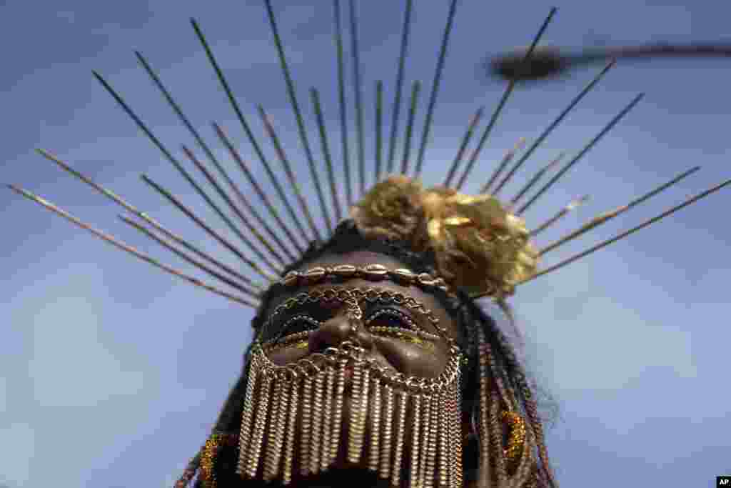 A reveler performs at the "Cordao do Boitata" street party, one of the many parades before the start of Carnival which begins on Feb. 21, in Rio de Janeiro, Brazil.