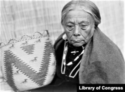 This ca. 1913 photo by Edward S. Curtis shows a Skokomish woman from Washington state holding a woven basket. Tribal arts and crafts draw on traditions passed down for generations.