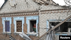 A municipal worker inspects a house damaged by a Russian drone strike, amid Russia's attack on Ukraine, in Zaporizhzhia, Ukraine, Nov. 25, 2024. 