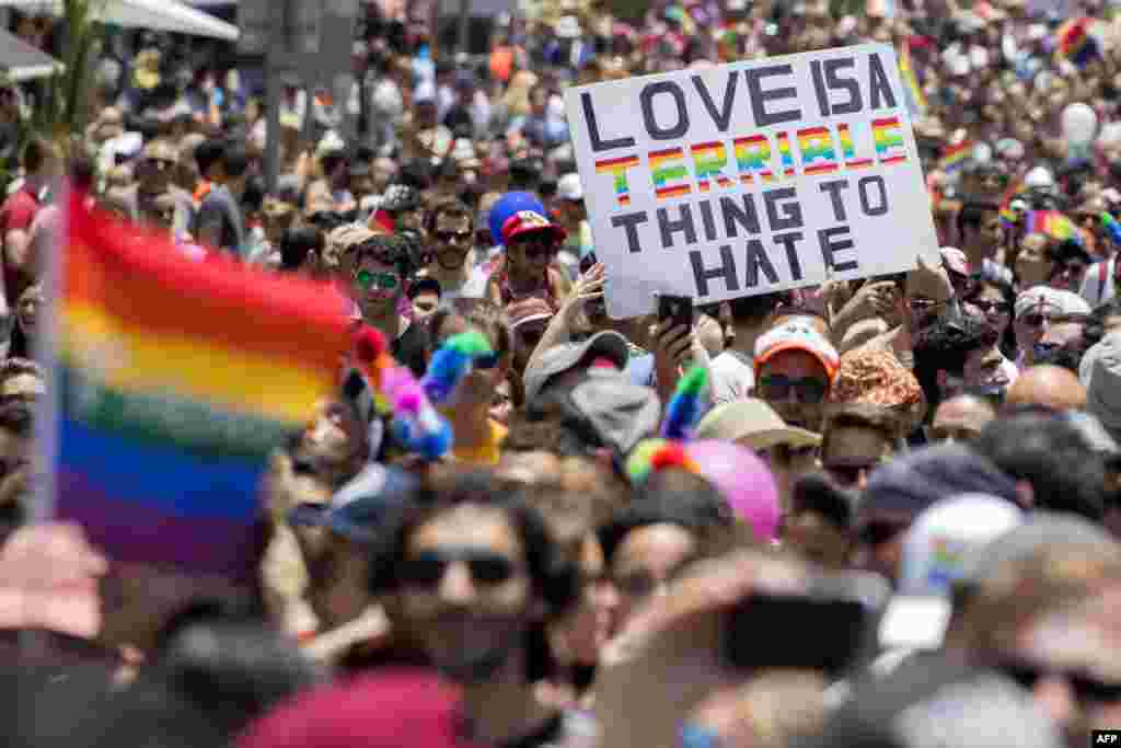 Participants take part in the annual Gay Pride parade in the Israeli city of Tel Aviv. Tens of thousands of revelers from Israel and abroad packed the streets the city's annual Gay Pride march, billed as the Middle East's biggest.